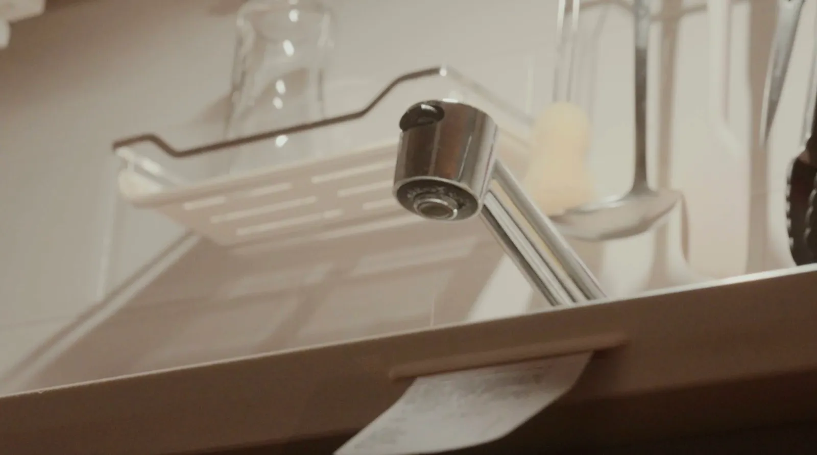 A receipt spooling out from under the bathroom tap