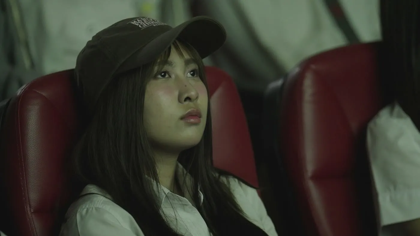 An audience member looking up at the screen