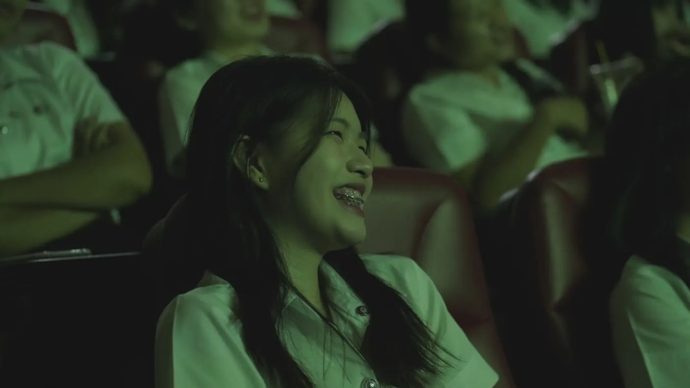 An audience member laughing