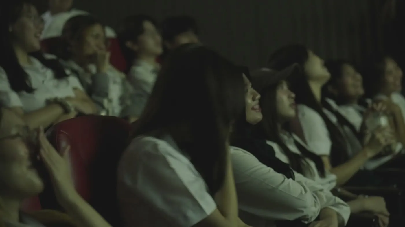 A row of people watching the screen together